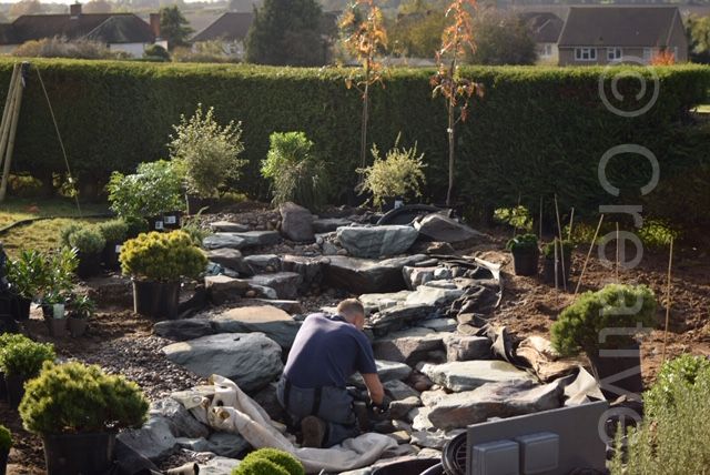 Bigger rocks look more natural but are more costly. 70% through an eco-system pond build with large rock waterfalls, Bishops Stortford  - Landscaping and Water Features -  Creative Cascades