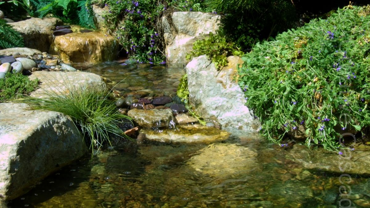 Small waterfall in limestone rocks, flowing into eco-pond, size in keeping with small garden setting. Lower cascade is only just above pond height to generate sufficient pond flow.  - Landscaping and Water Features -  Creative Cascades