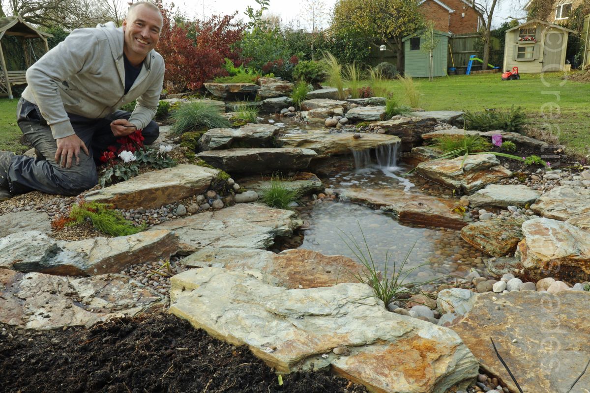 Me at a freshly completed pondless waterfall  - Landscaping and Water Features -  Creative Cascades