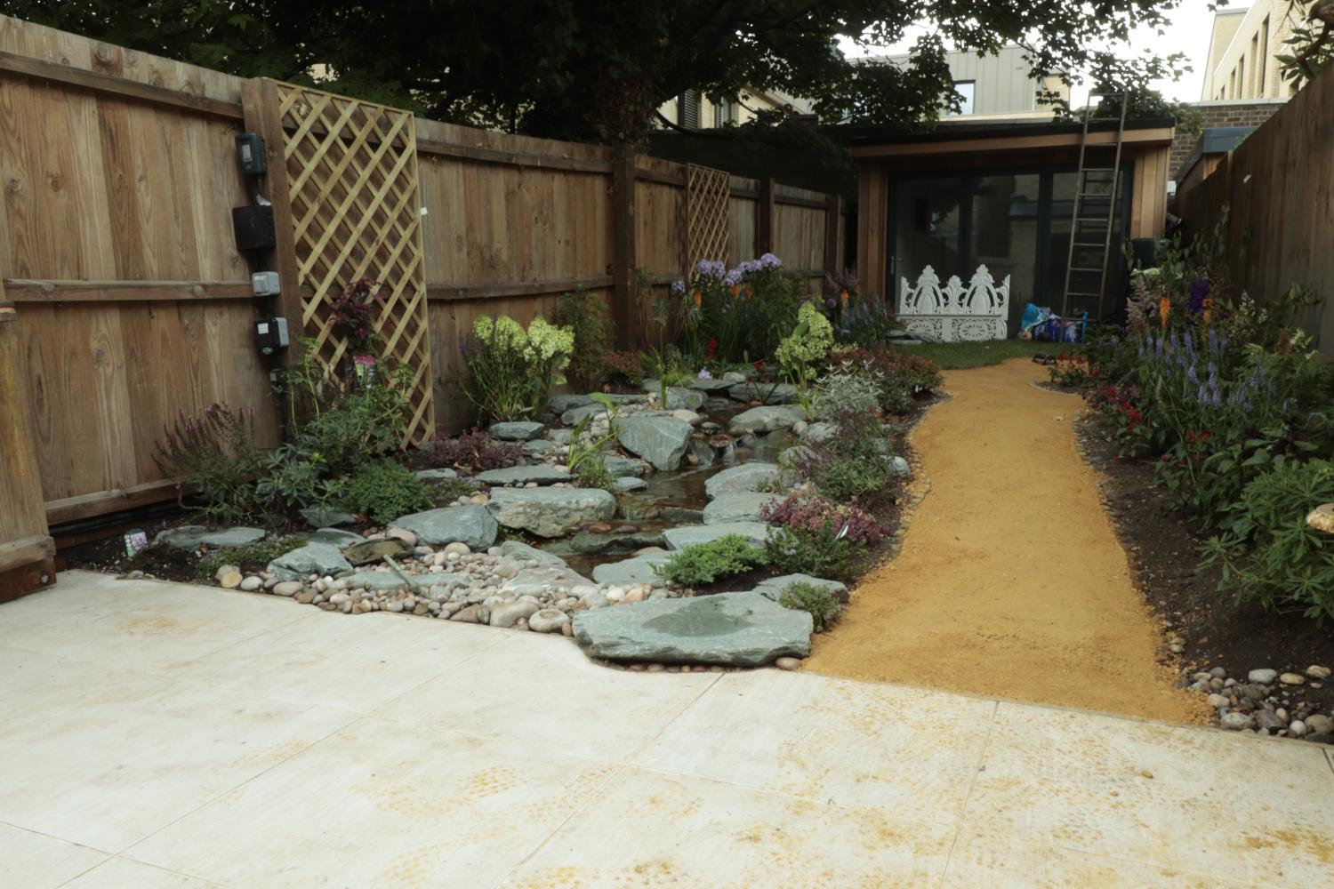 This was a jungle 2 weeks prior, we remodeled the entire space and added this stream  - Landscaping and Water Features -  Creative Cascades