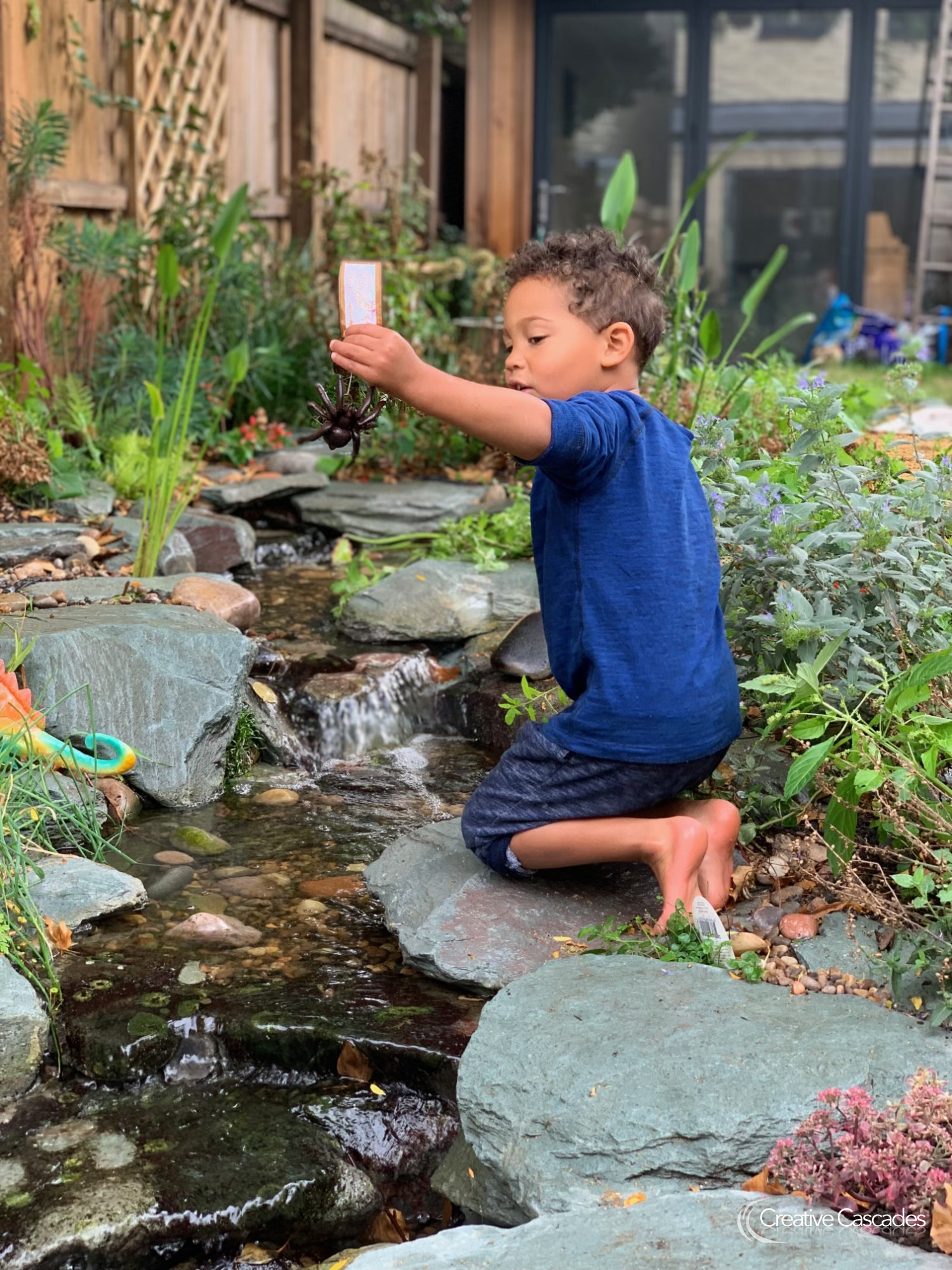 Our Client's Grandson is obsessed with their new feature!  - Landscaping and Water Features -  Creative Cascades