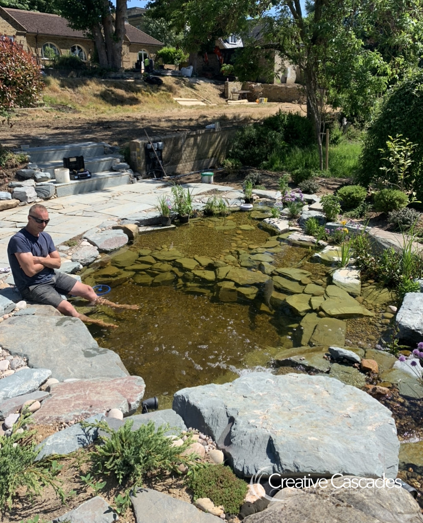 Richard looking over a pond build. Our clear water ecosystems can be scaled to any size.  - Landscaping and Water Features -  Creative Cascades